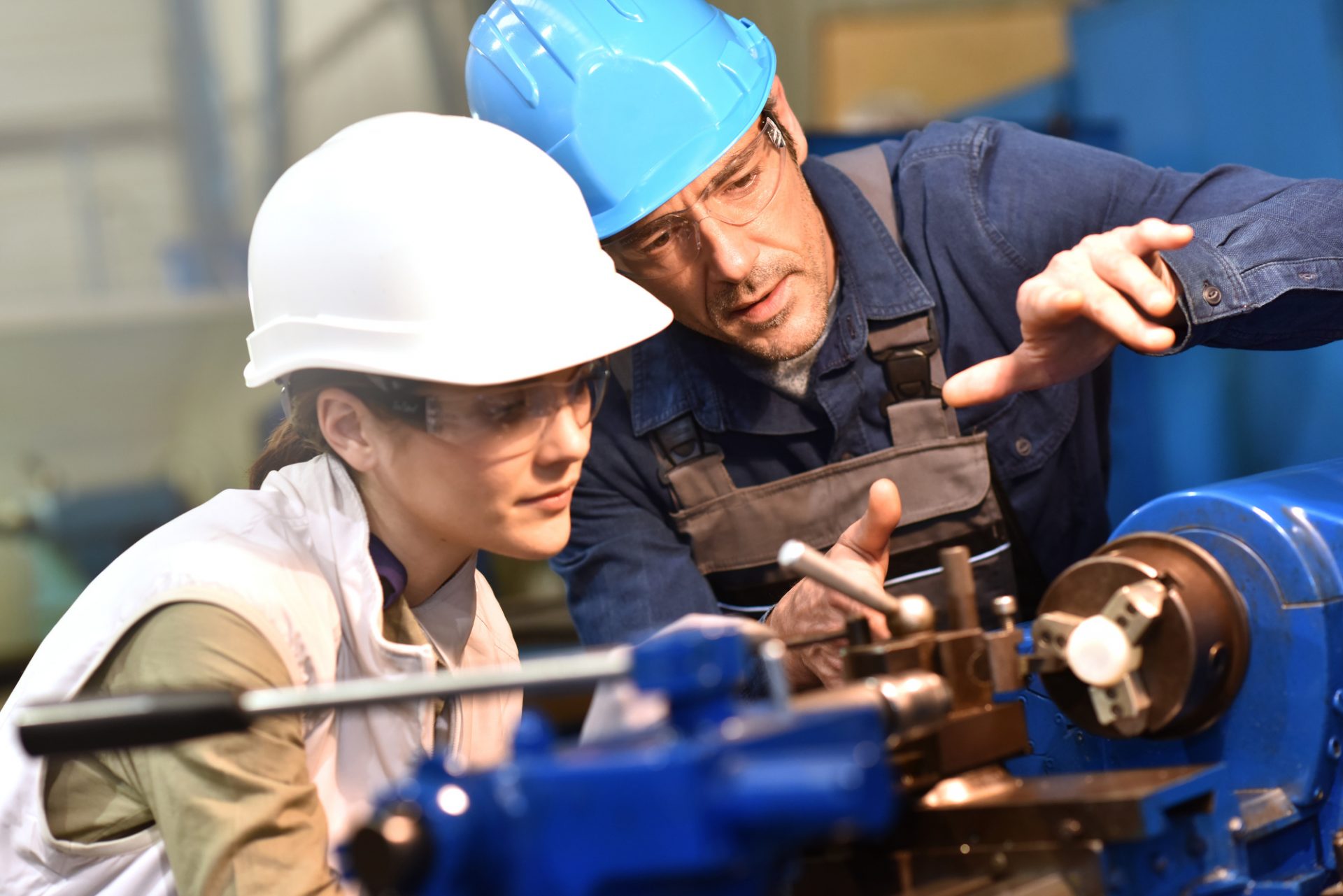 Manufacturing engineers collaborating around production equipment